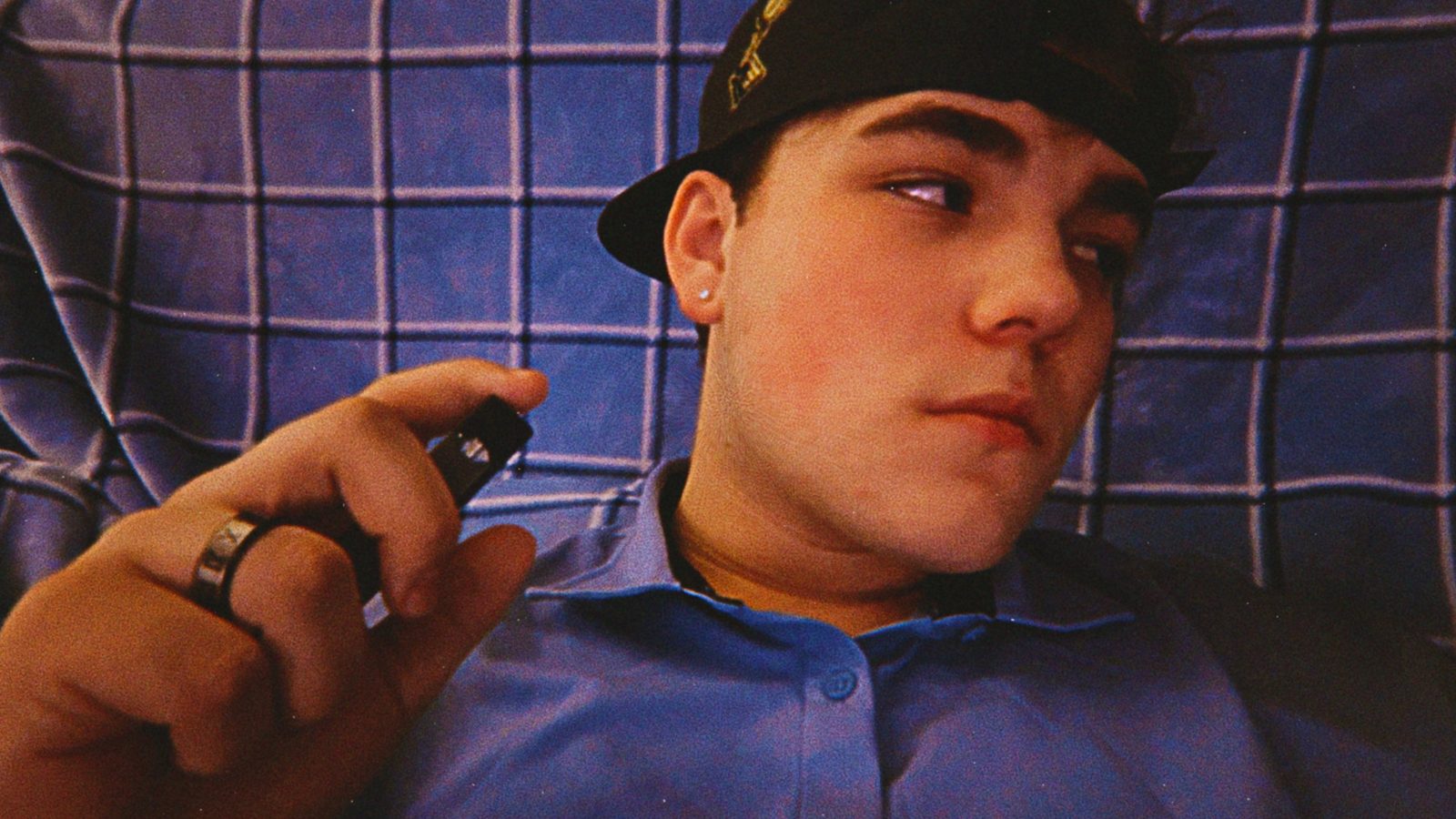 Nathan Etes lying back on a blue plaid blanket